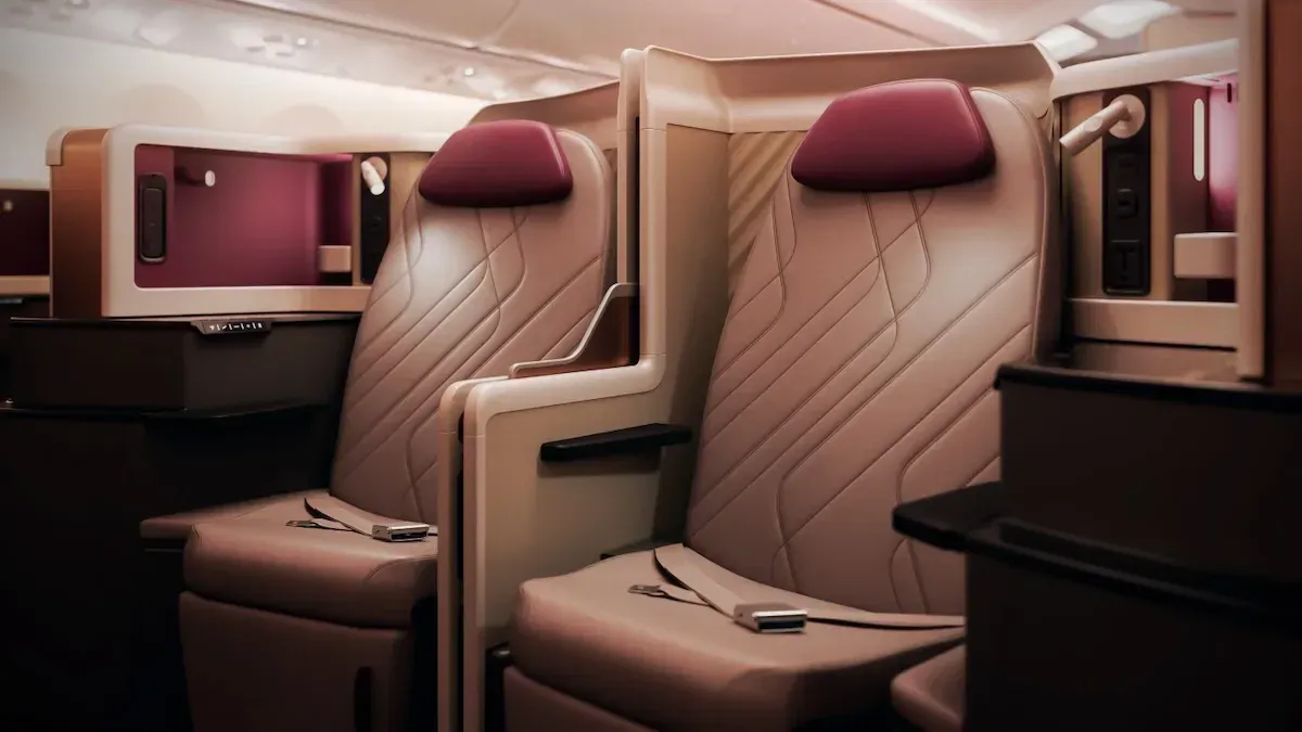 Two premium business-class suites with burgundy headrests in a wide airliner cabin.