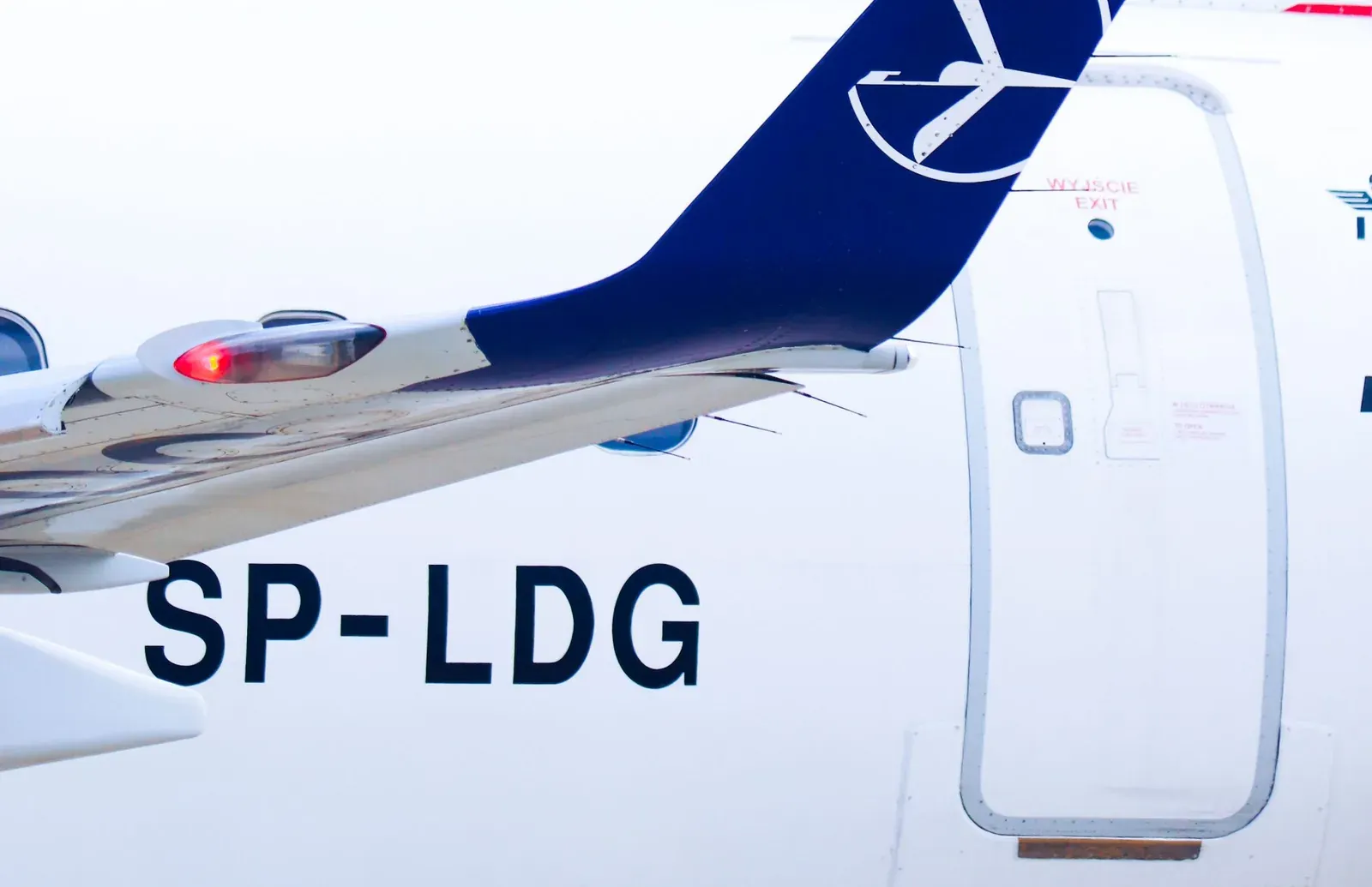 The rear fuselage of an airliner showing its registration, SP-LDG, painted in large black letters.